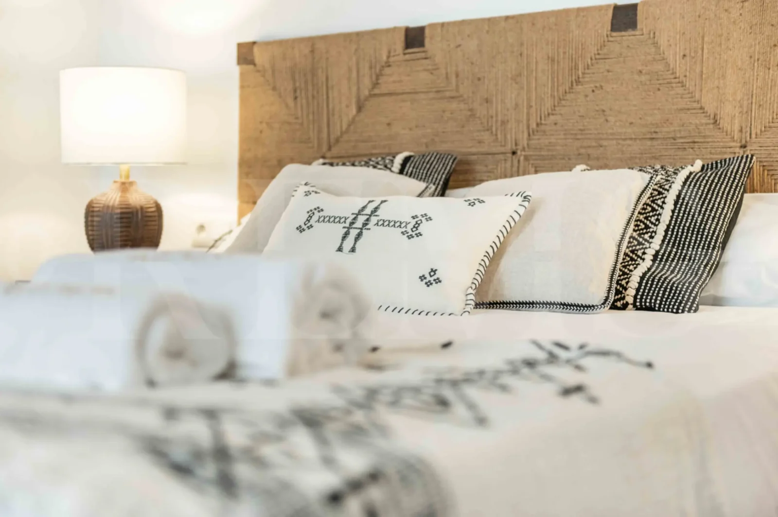 Serene master bedroom with soft linens, neutral tones, and artisan décor in a luxury Malaga accommodation for Charity Ace travelers.