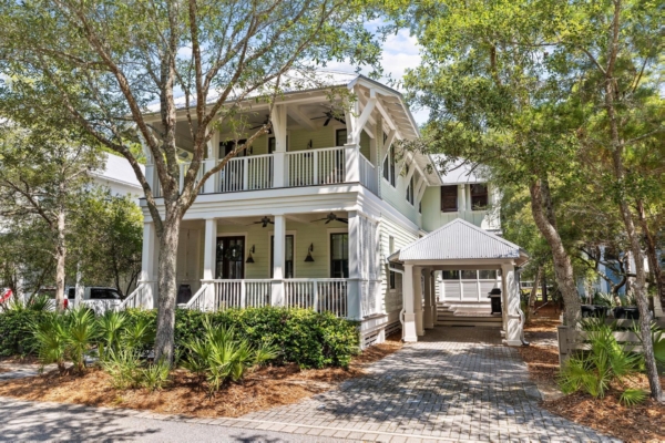 Exterior view of a luxury two-story vacation home with large porches in Watercolor, Florida