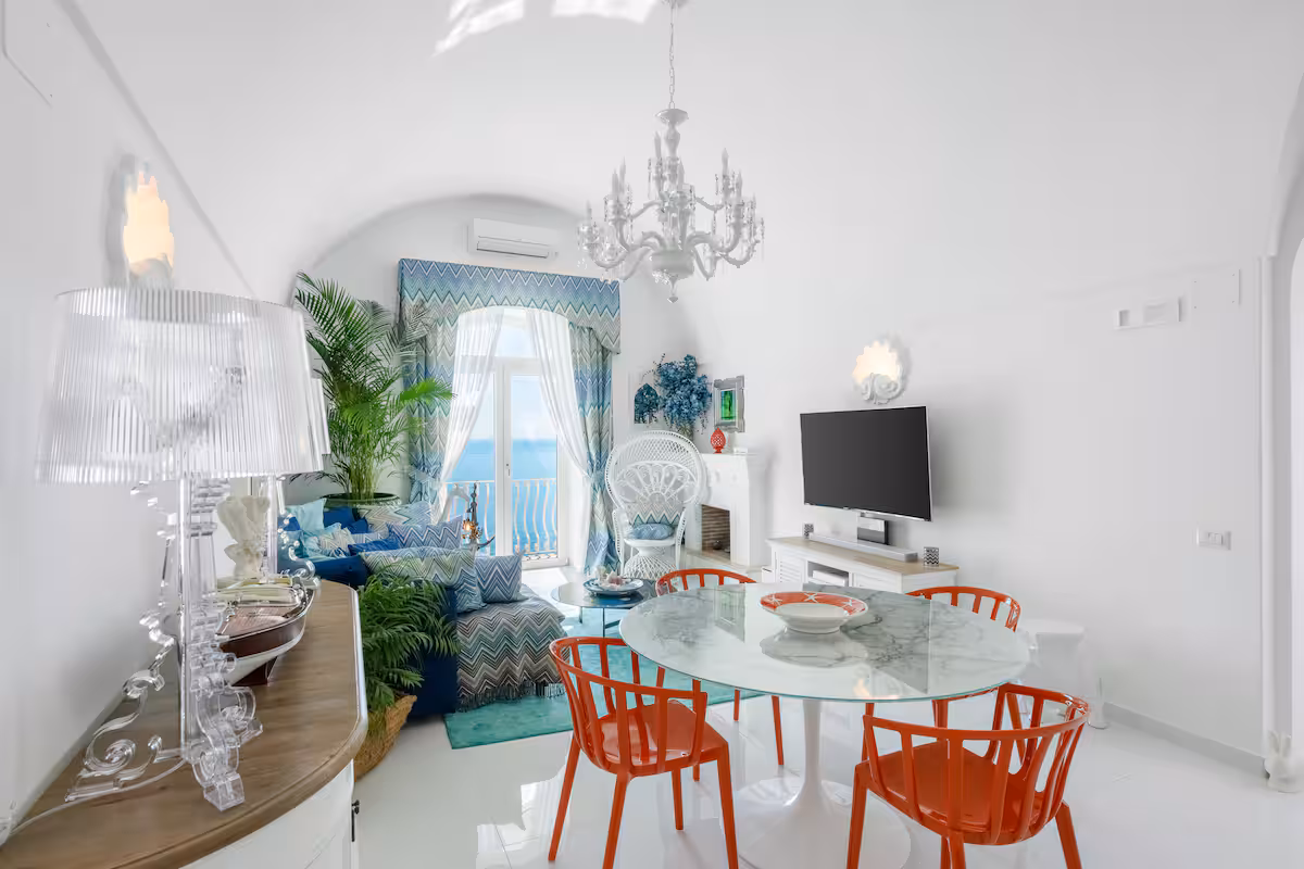 Charming whitewashed villa with private terraces and vibrant garden nestled in the cliffs of the Amalfi Coast, Italy.