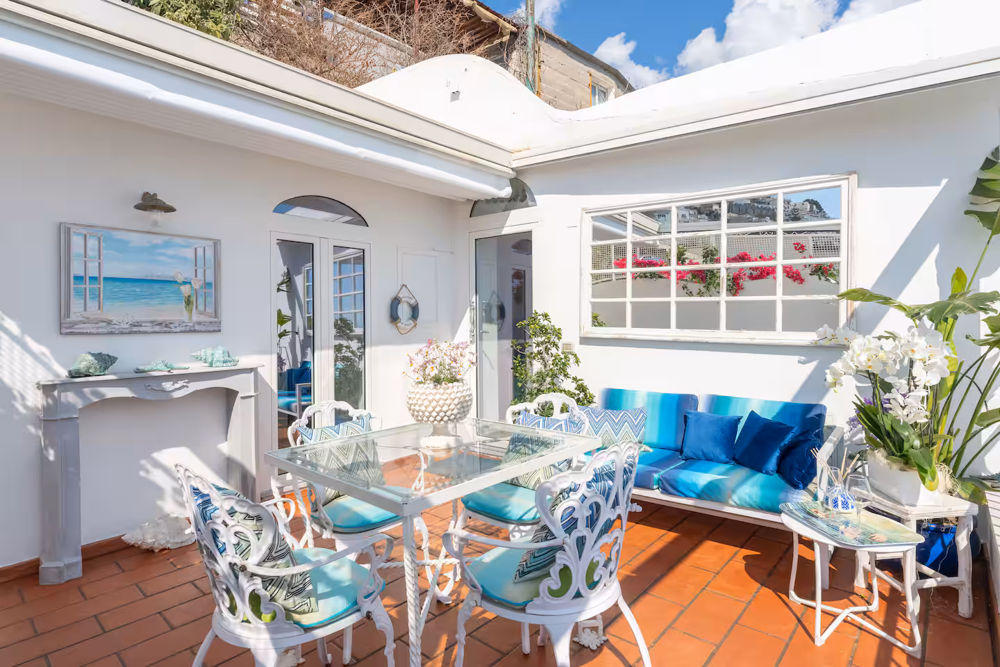 Open-air terrace with panoramic views of the Mediterranean Sea and chic coastal decor.