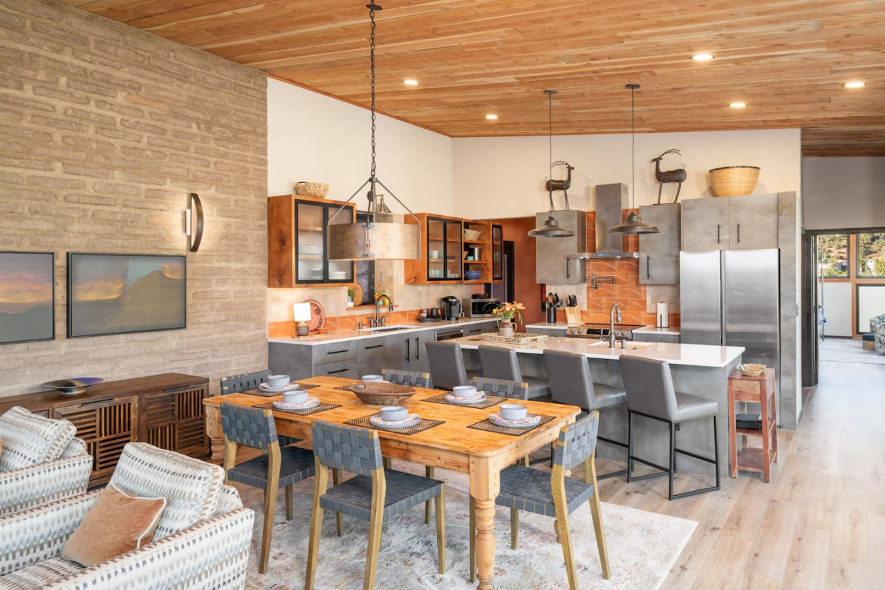 Open-concept kitchen and dining area with natural wood finishes in Sedona vacation home.